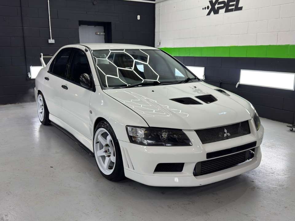 White Mitsubishi Lancer Evolution in a garage